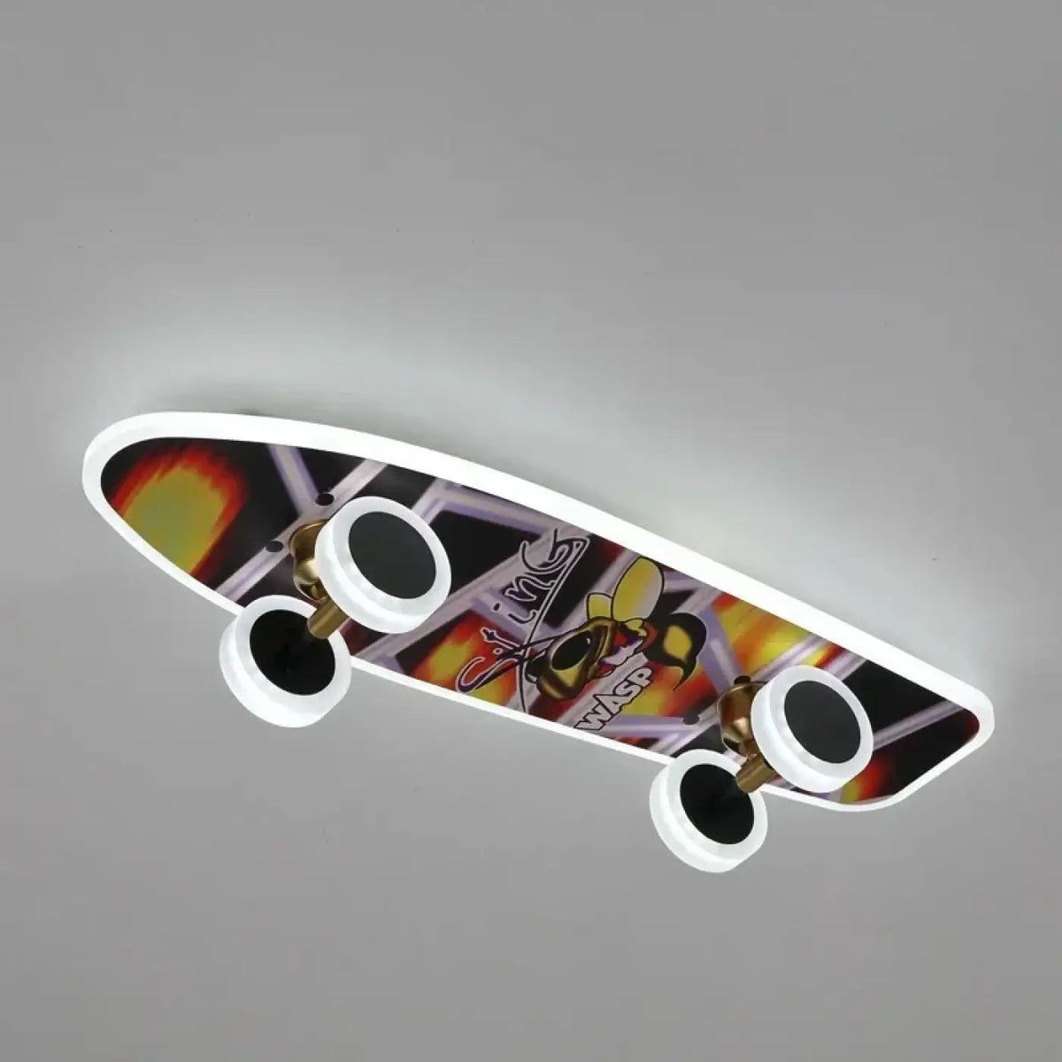 Plafonnier LED skateboard Dalumea, modèle Graffiti : planche à lettrages orange et violet, contour lumineux et quatre roues éclairantes